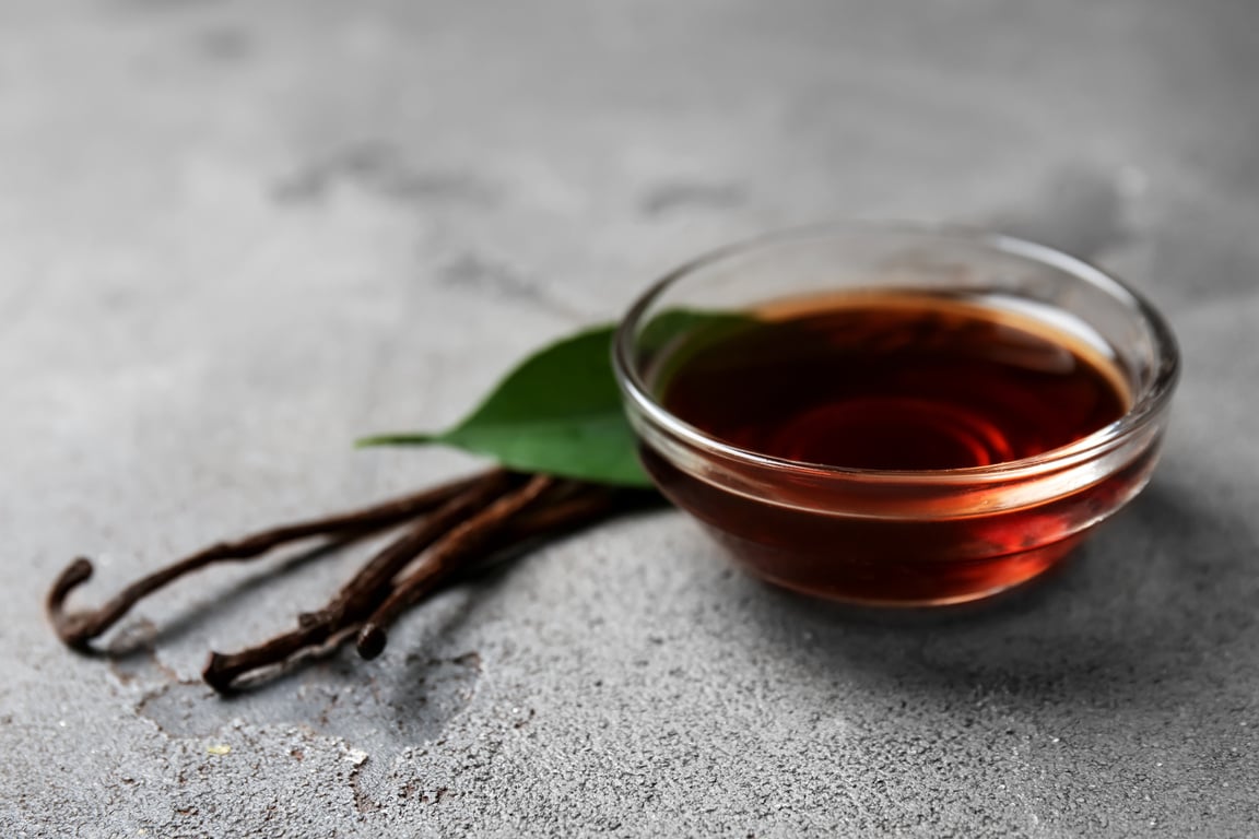 Glass Bowl with Vanilla Extract on Table